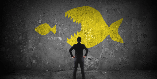 a person standing in front of a wall with a yellow and black fish
