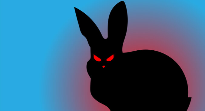 a silhouette of a rabbit with red eyes