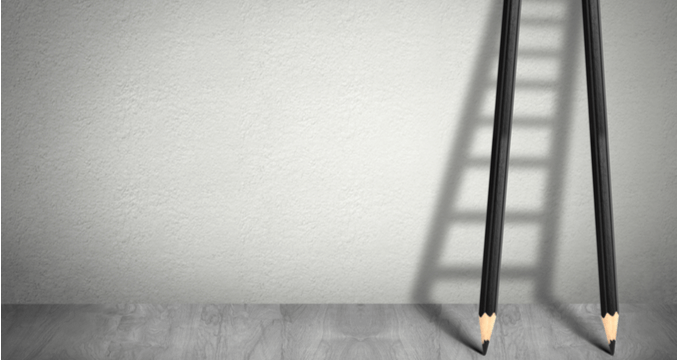 pencils leaning against a wall to look like a ladder