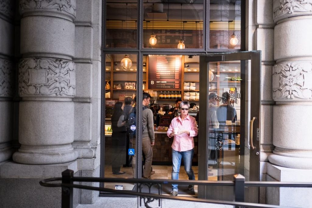 a person standing in front of a glass window