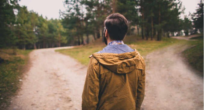 a man walking on a dirt road