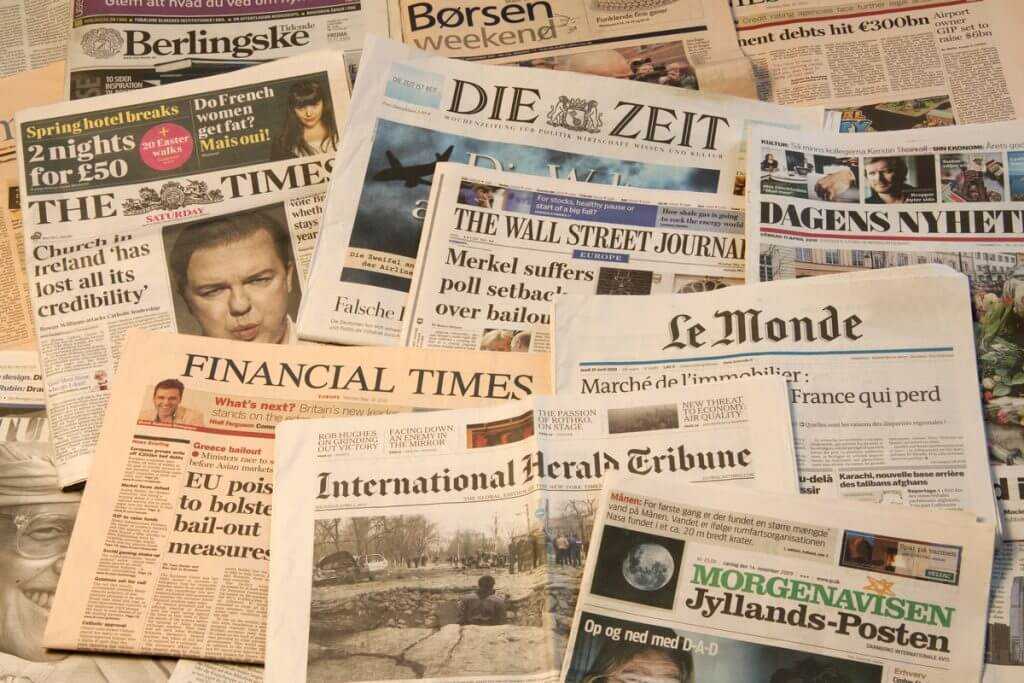 stack of newspapers showing their headlines