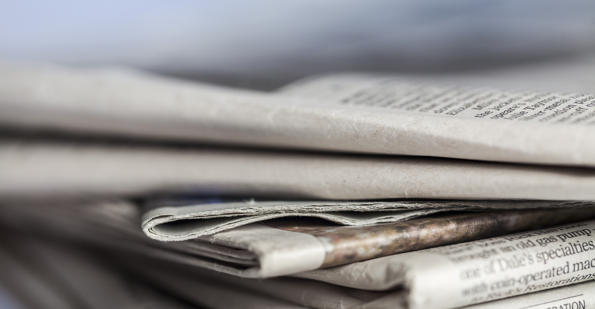 a pile of folded newspapers